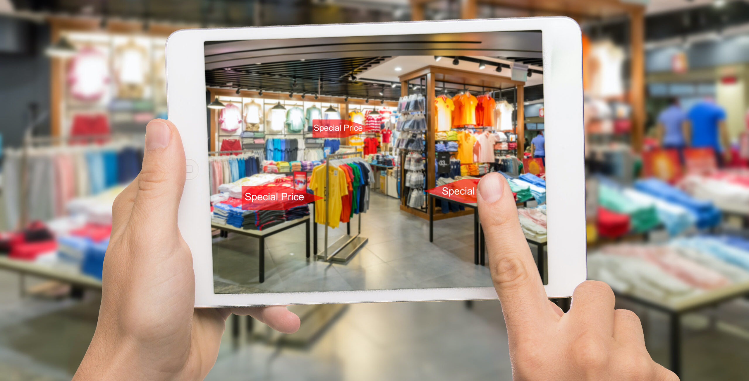 augmented reality marketing concept. hand holding digital tablet smart phone use ar application to check special sale price in retail fashion shop mall